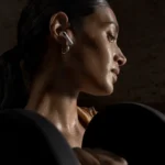 Apple AirPods 5 with charging case showing the new open-ear design and ANC earbuds