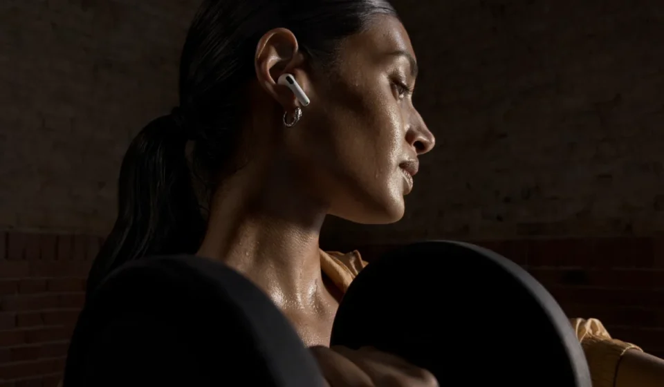 Apple AirPods 5 with charging case showing the new open-ear design and ANC earbuds